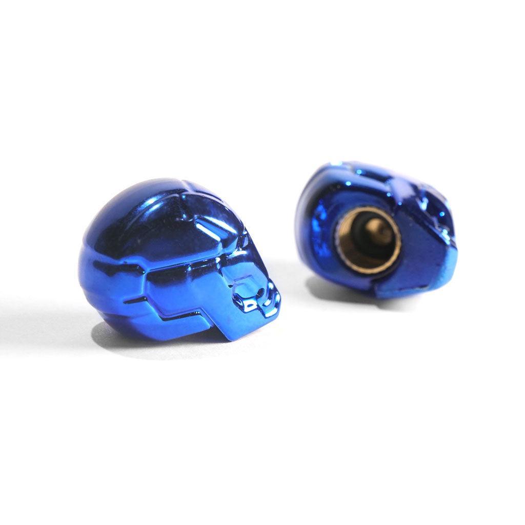 Superhero Valve Caps (Pair) in metallic blue, with a helmet-inspired design, are shown on a white background—one displays the exterior while the other reveals its inner connector.