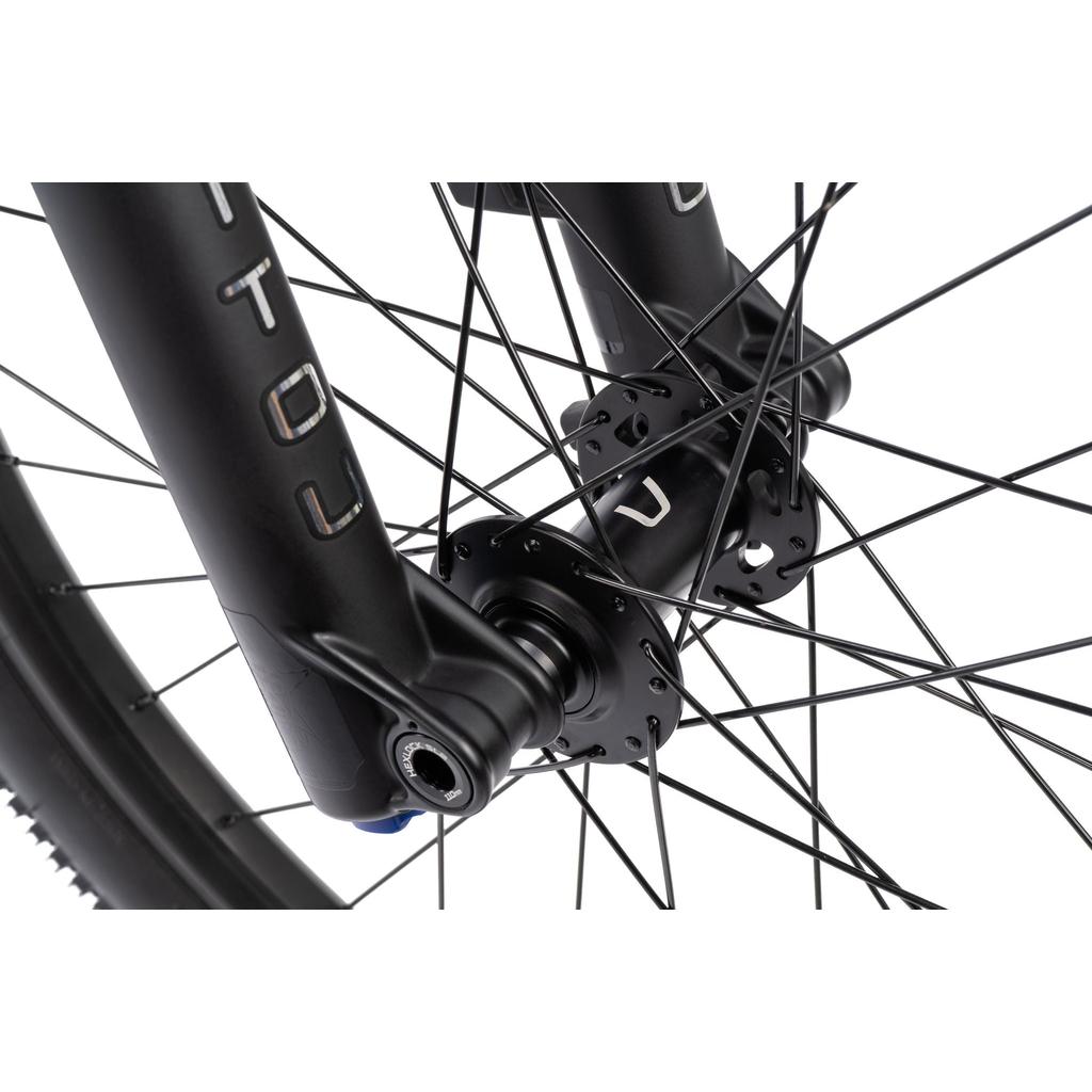 Close-up of the Radio Griffin 24 Inch Dirt Jumper Bike’s front wheel hub and spokes on a black fork, showcasing detailed components and assembly on its 24” aluminum frame.