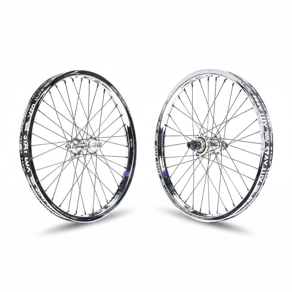 The Tall Order X Birdcage Custom Wheelset features two metal-spoked wheels with black-and-silver rims, standing upright on a white background—ideal for BMX bikes or as a custom upgrade.