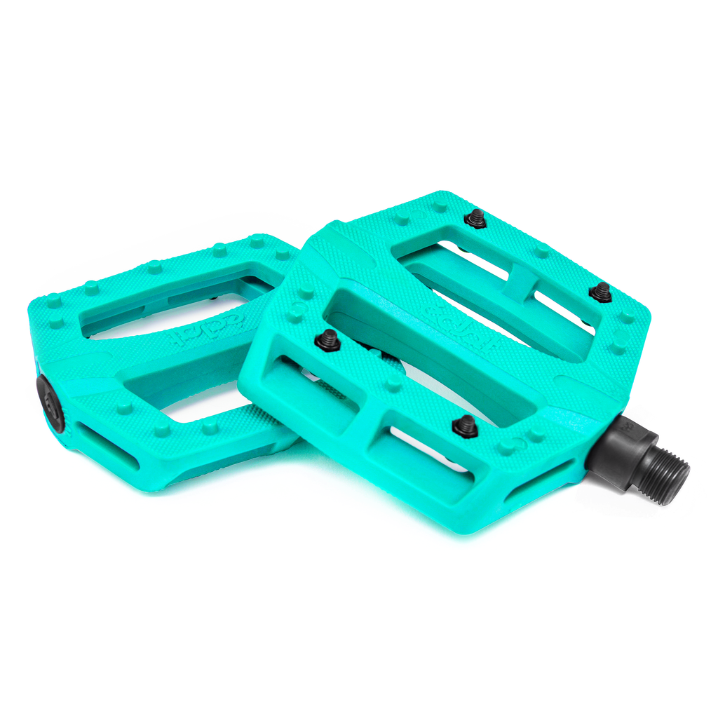 A pair of turquoise pedals, the Eclat Contra Pedals, on a white background.