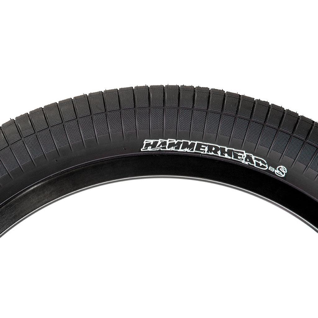 Close-up of a black Demolition HammerHead S Tyre with textured tread and "HAMMERHEAD S" in white on the sidewall, featuring durable wire bead construction for reliable performance.