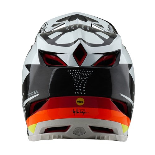 The TLD 25.1 D4 Carbon Helmet (MIPS) in Optic Black features a black and white design with red and orange accents, ideal for downhill BMX. It highlights angular designs, rear vents, and prominently displays the MIPS logo at the bottom.