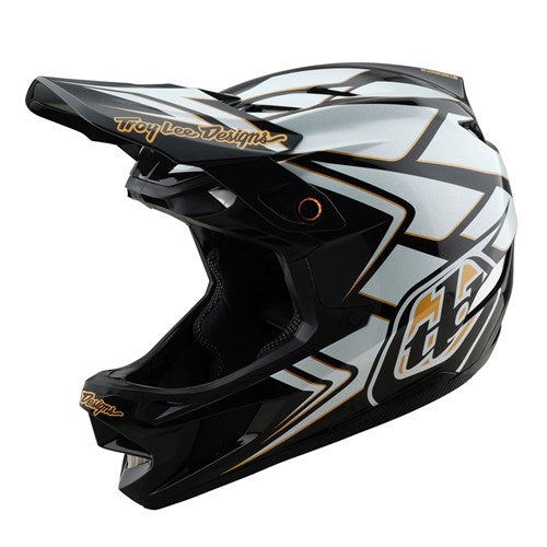 The TLD 25.1 D4 Composite Helmet (MIPS) in Ghostwing White boasts a black and white design with angular patterns and "Troy Lee Designs" on the visor. Ideal for downhill BMX, it offers Mips C2 protection for superior safety without sacrificing style.