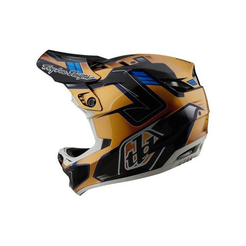 The TLD 25.1 D4 Composite Helmet (MIPS) in Royalty Black/Gold boasts a geometric design with gold, blue, and black. It features the advanced Mips® C2 system for protection, along with a visor and ventilation openings for a stylish and safe ride.