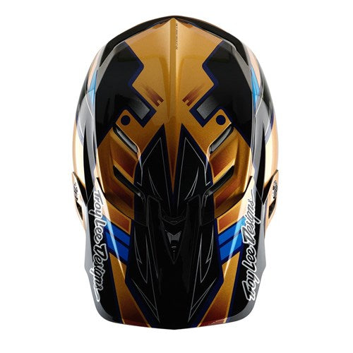 Front view of the vibrant TLD 25.1 D4 Composite Helmet (MIPS) in Royalty Black/Gold, showcasing intricate geometric designs with "Troy Lee Designs" on the sides, offering enhanced safety through MIPS protection.