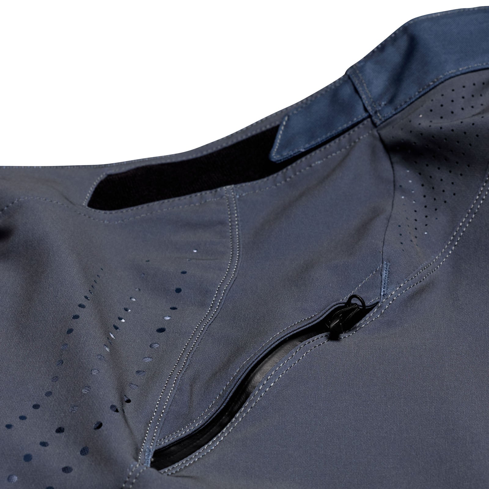 Close-up of the TLD 25.1 Sprint Pant in Mono Steel Blue, featuring a zippered pocket and perforated design. The lightweight, race-ready material makes it ideal for activewear pursuits.