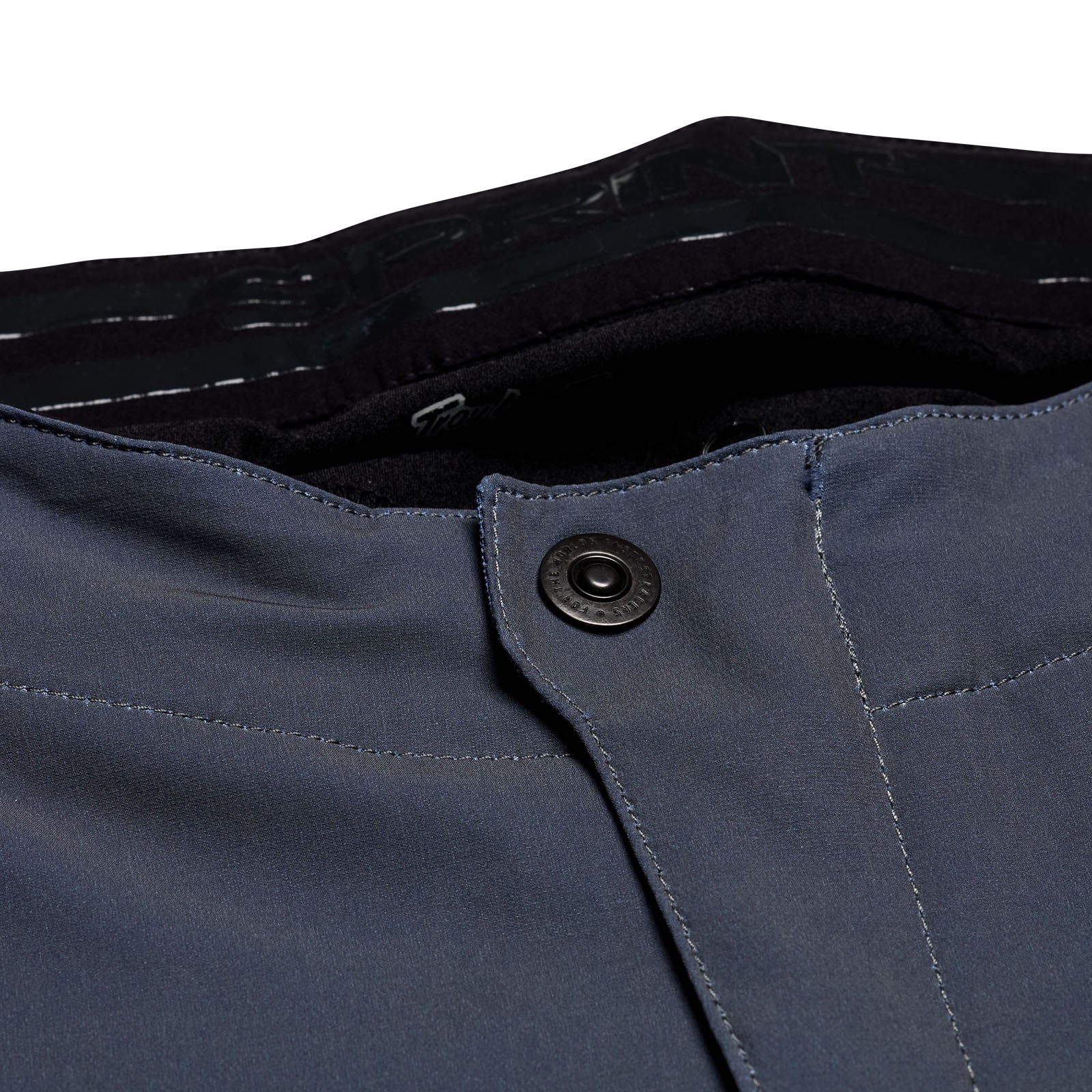 Close-up of TLD 25.1 Sprint Pant in Mono Steel Blue, featuring waistband with a black button. Inner waistband displays some black text, making these pants race-ready for any adventure.