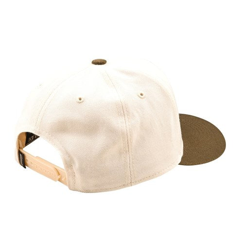 The TLD 25.1 Stamp Curved Hat is shown from the back with beige and brown hues, ideal for daily wear. It offers comfort with an adjustable strap and two ventilation holes.