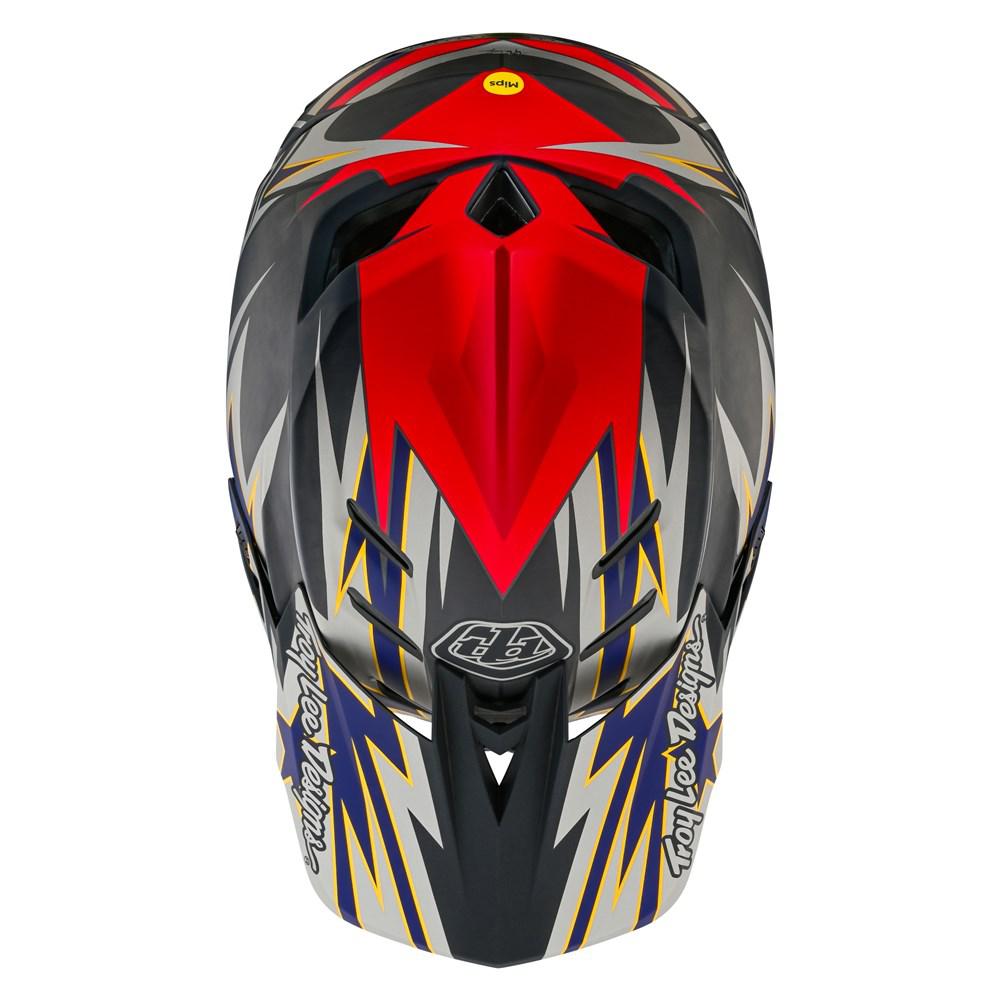 A TLD D4 Carbon AS Helmet W/MIPS Inferno Grey with a red and blue design, featuring TeXtreme® Spread Tow carbon fiber reinforcements.