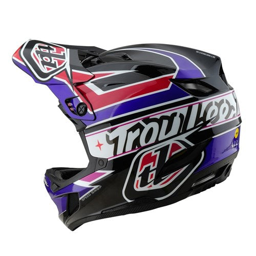 The TLD D4 Polyacrylite Helmet (MIPS) in Linear Black is a purple, black, and red full-face helmet with a visor and "Troy Lee" branding.