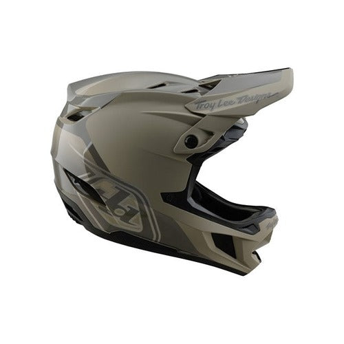 The TLD D4 Polyacrylite Helmet (MIPS) in Shadow Timber is a matte gray full-face helmet with a polyacrylite shell and visor, featuring "Troy Lee Designs" on the side and top, and includes Mips brain protection for enhanced safety.
