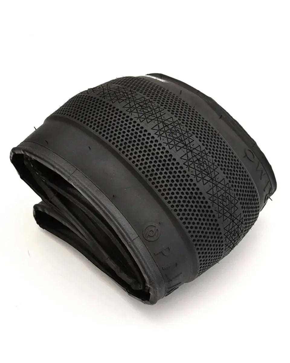 A Primo Richter 20 Inch Folding Tyre in black, sized 20x2.4 with a patterned tread and smooth sidewalls, is displayed on a white background, showcasing its lightweight folding tire design.