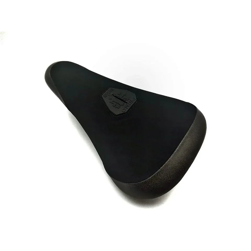 Primo Balance Pivotal Seat – a black pivotal BMX seat featuring a textured surface and a small hexagonal badge with the Primo logo centered on the seat. Inspired by classic Primo street seats, this design delivers both style and comfort to meet all your BMX cushioning needs. Shown against a plain white background.