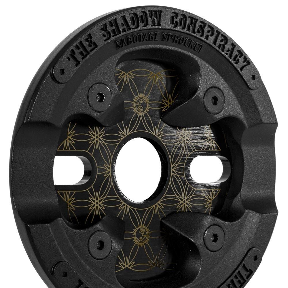 Black metal Shadow Sabotage Maya Edition V2 Sprocket with gold geometric patterns—Joris Coulomb signature design.