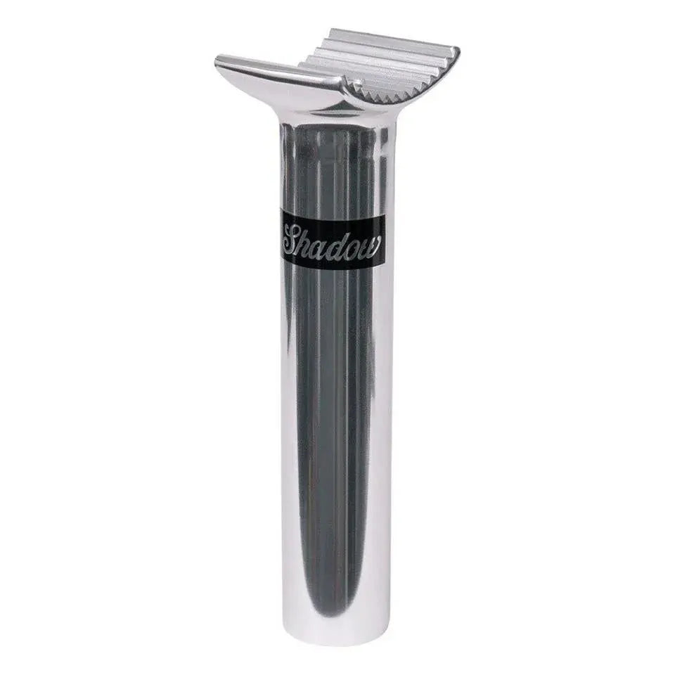 The Shadow 135mm Pivotal Seat Post is silver with a ridged clamp top, features “Shadow” on a black band, and is made from durable 6061 forged alloy for lasting performance.