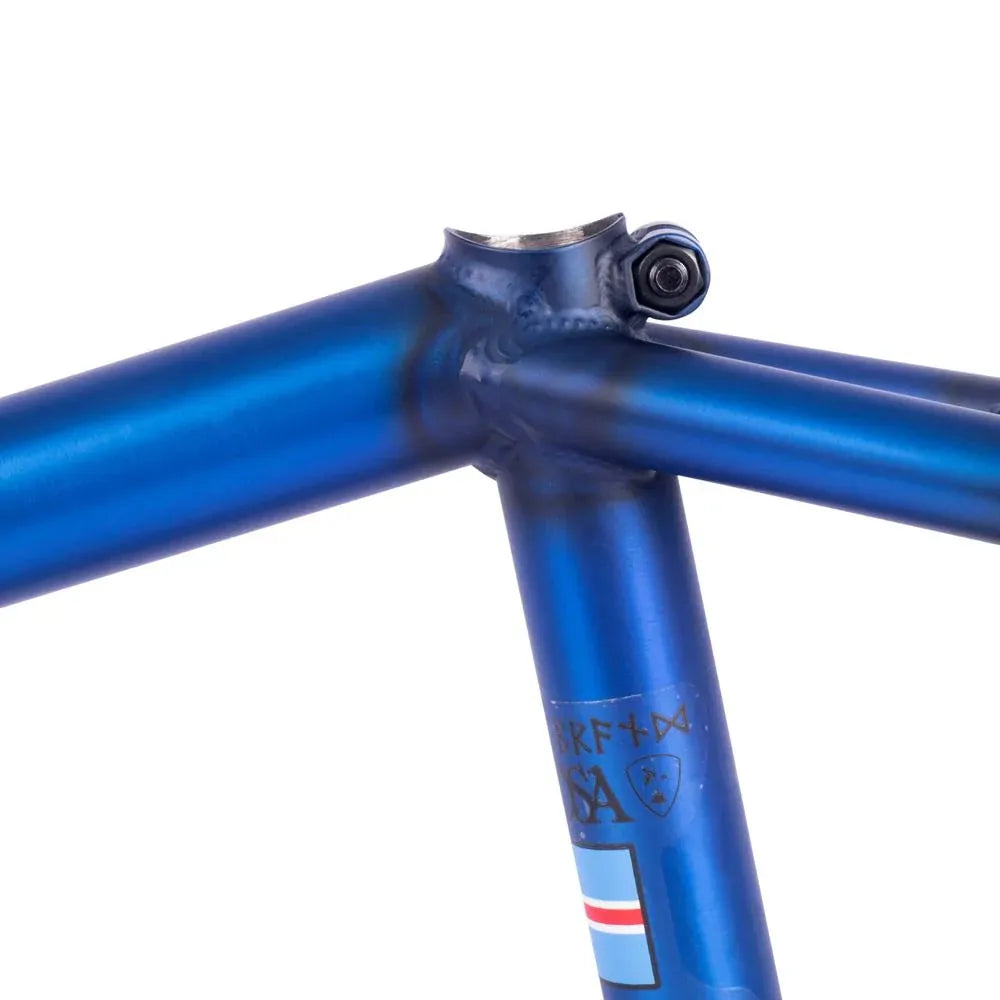 Close-up of the Subrosa MRIII Frame (Bjarki Hardarson Colorway) in blue, highlighting the chromoly welded joint where the top tube, seat tube, and seat stay connect, with part of a seat tube decal visible.