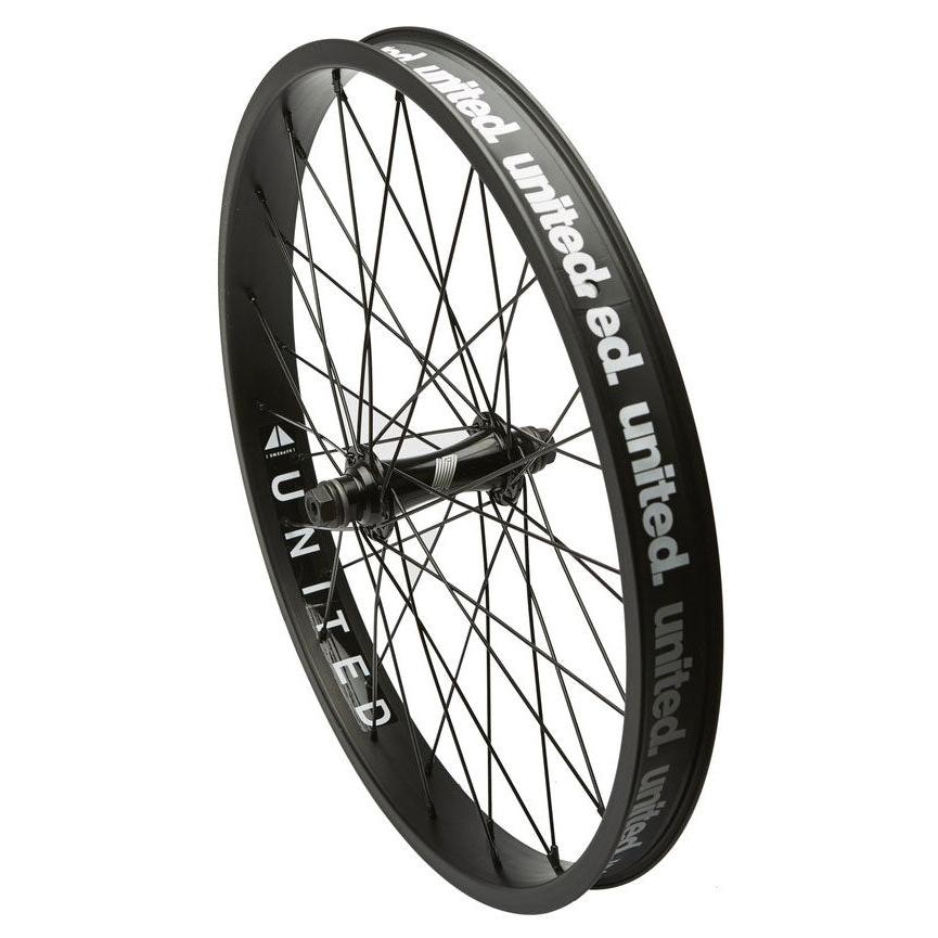 A black United Supreme front wheel with visible spokes and branding on the double-walled rim.