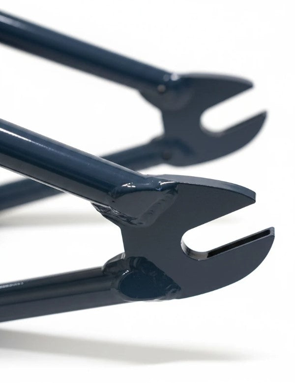 Close-up of two dark blue fork dropouts from the United Pro Model Frame (Marius Dietsche Signature)—crafted from 4130 Sanko Japanese tubing—against a white background.