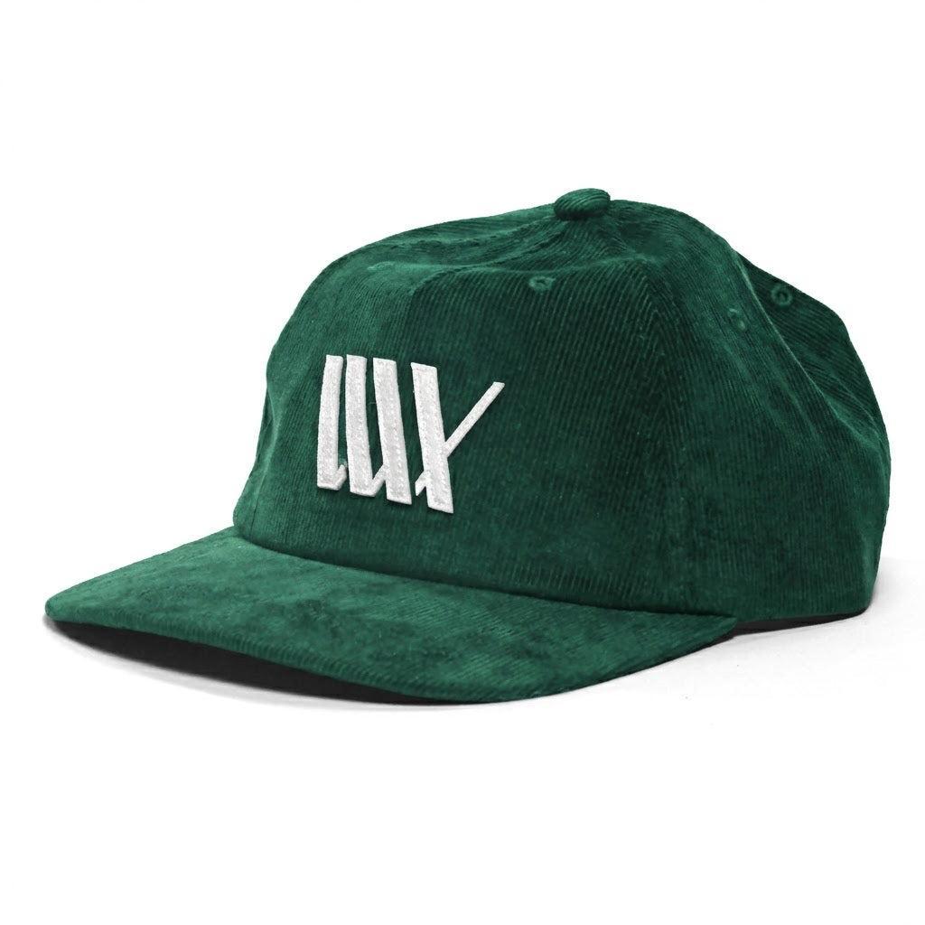 The LUXBMX Outfield Cap Bottle Green is a stylish corduroy baseball cap with a white embroidered LUX logo, perfect for adding flair to your casual outfit.