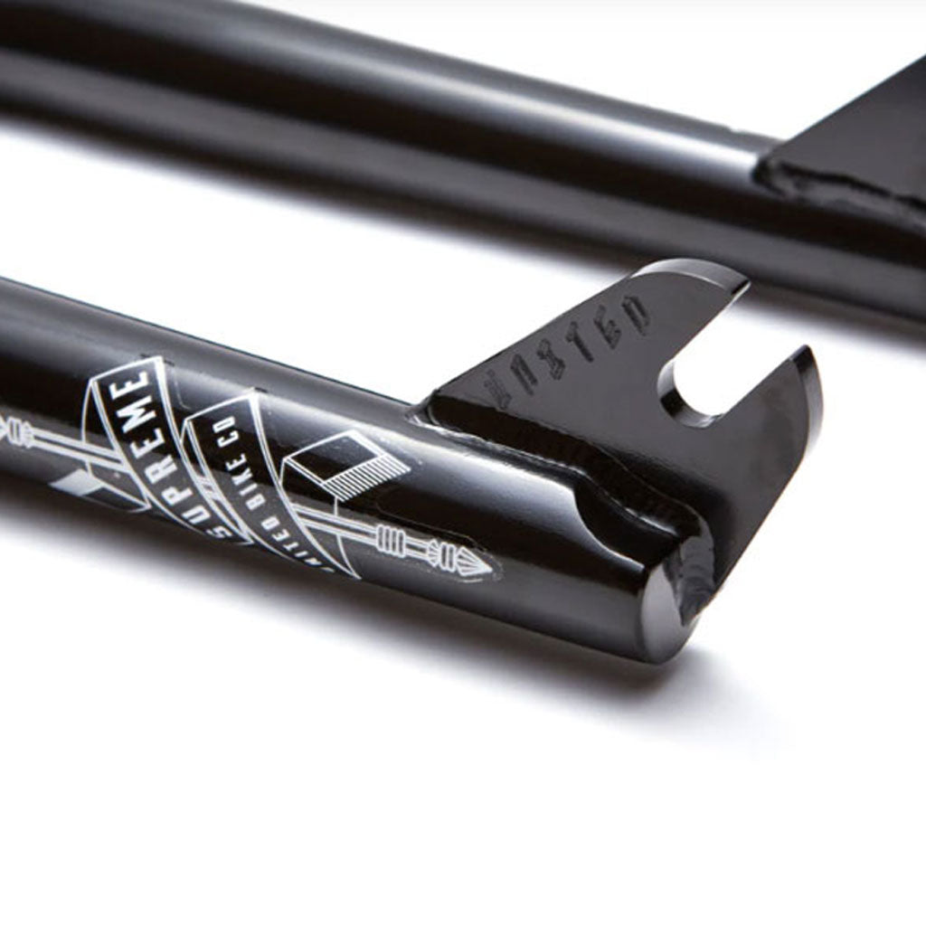 Close-up of a black lacrosse stick shaft with "United Supreme Fork V2" branding and measurement markings.