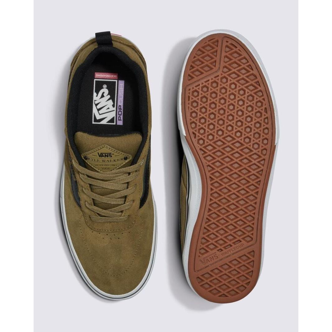 A pair of Vans Pro Skate Kyle Walker sneakers in Gothic Olive shown from the top and bottom views. The left shoe displays the insole branding, while the right shoe showcases the DURACAP™ reinforced tread pattern of the WAFFLECUP™ rubber sole.