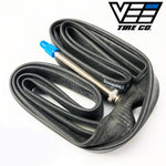 A Vee 20 X 1-1/8 Inch Tube (FV60mm) tire with a blue valve attached to it.