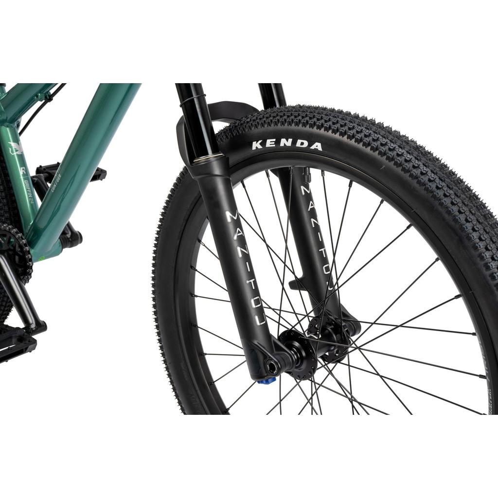 Close-up of the Radio Griffin 24 Inch Dirt Jumper Bike’s front wheel, featuring a Kenda tire, Manitou suspension fork, disc brake, and part of its green frame.