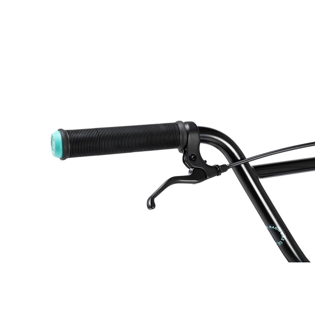 Close-up of the Radio Saiko 20 Inch Bike handlebar, showcasing a black rubber grip with turquoise end cap, Salt Tracer Tyres, and a brake lever—ideal for young BMX enthusiasts.