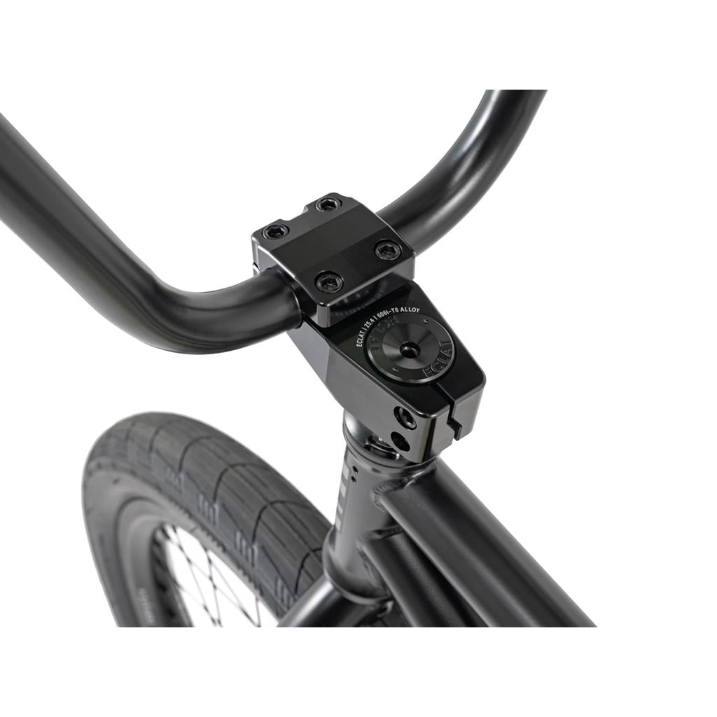 Close-up of the Wethepeople 20 inch Envy Carbonic LTD Bike in black, highlighting the handlebars, stem, and front tire with carbon fibre rims against a white background.