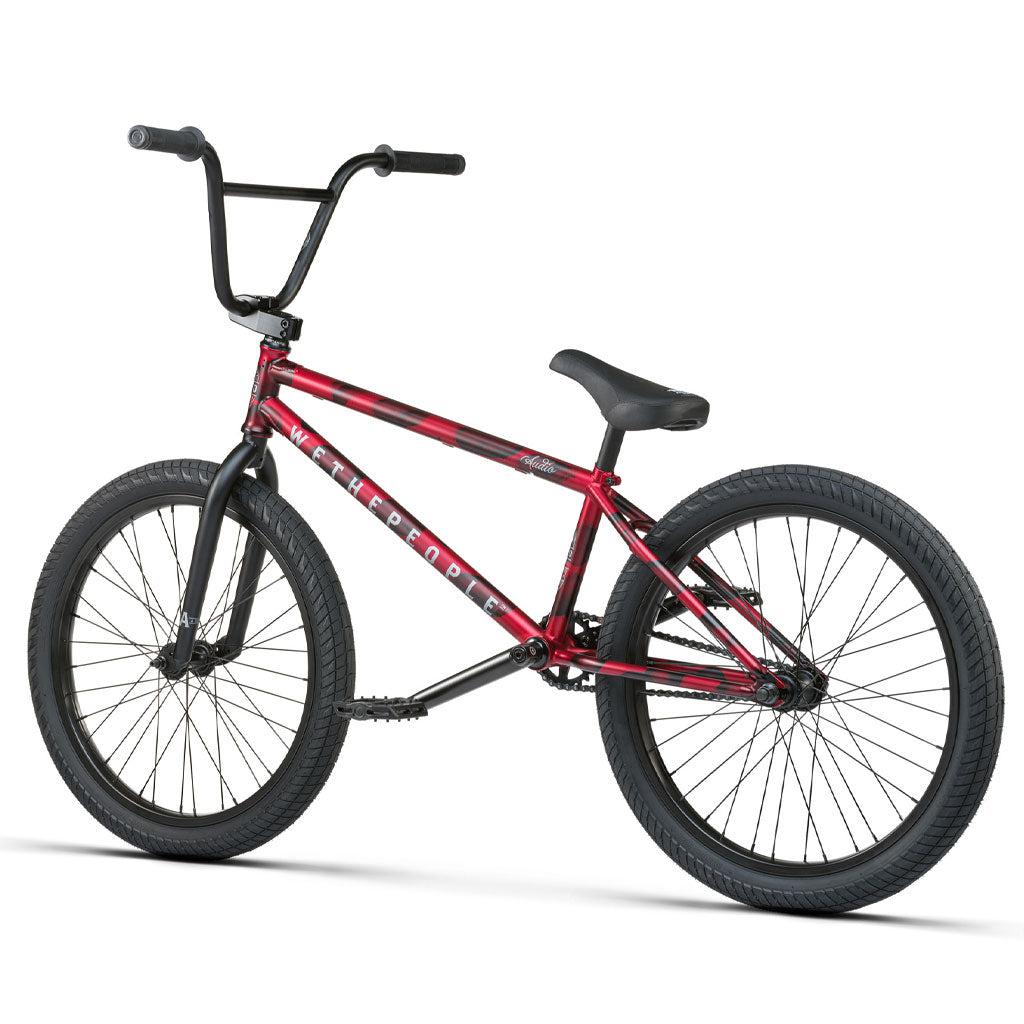 A Wethepeople Audio 22 Inch Bike featuring a red BMX style with black handlebar grips, black tires, and a durable chromoly frame.