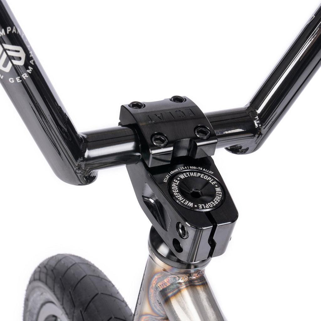 Close-up view of the Wethepeople Battleship 20 Inch Bike's black BMX handlebar and stem, connected to the front fork with visible Eclat branding on the components.