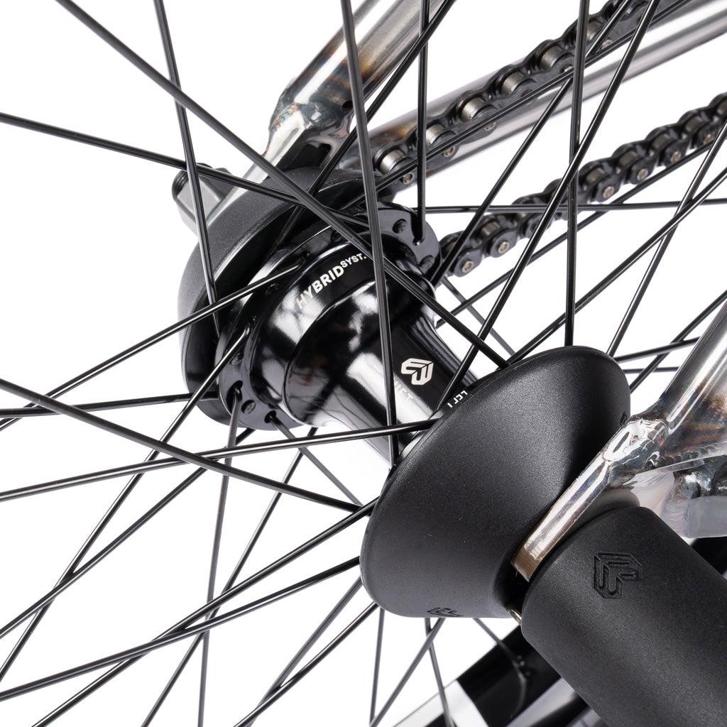 Close-up view of the Wethepeople Battleship 20 Inch Bike’s wheel hub, spokes, and chain, highlighting mechanical details and Eclat components branding on the hub.