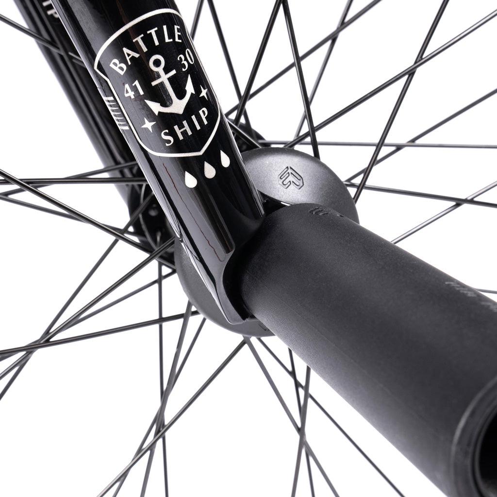Close-up of the Wethepeople Battleship 20 Inch Bike wheel hub, spokes, and black fork labeled "BATTLESHIP" with anchor graphic and Eclat components, photographed against a white background.