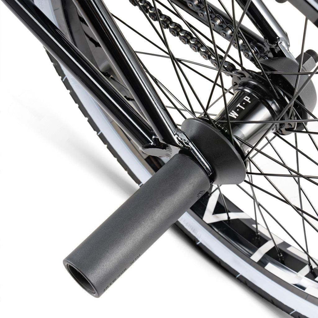 Close-up of the Wethepeople Battleship 20 Inch Bike’s rear wheel with Eclat components, including peg, hub, spokes, chain, and a black-and-white tire.