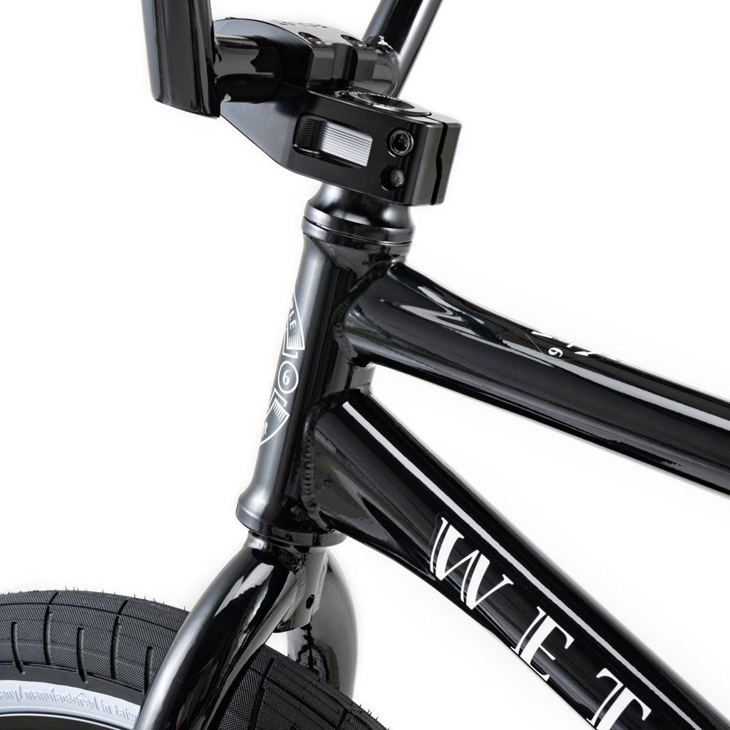 Close-up of the front section of a Wethepeople Battleship 20 Inch Bike, highlighting Eclat components on the handlebars, frame, and part of the front tire against a white background.