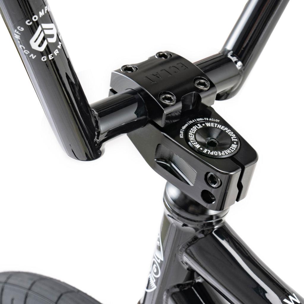 Close-up view of the Wethepeople Battleship 20 Inch Bike's black handlebar stem and headset, showcasing detailed Eclat components branding and hardware.