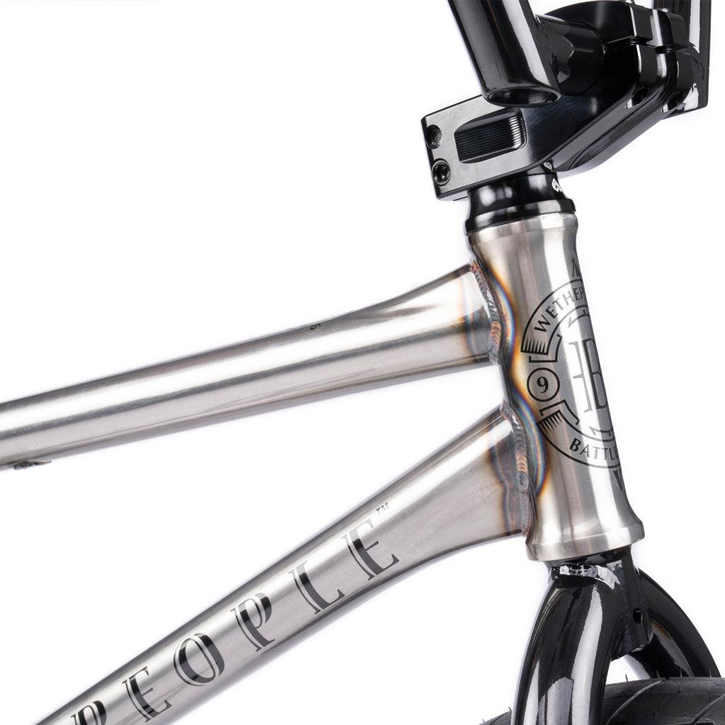 Close-up of the Wethepeople Battleship 20 Inch Bike’s metallic frame, highlighting the head tube, top tube, and handlebar stem with "WeThePeople" branding and a durable chromoly build.