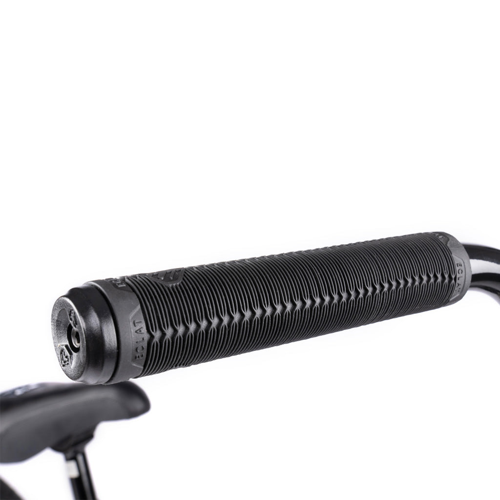 Close-up of a black handlebar grip with textured grooves and an end cap, attached to a Wethepeople Battleship 20 Inch Bike equipped with quality Eclat components.