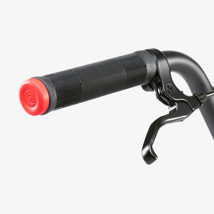 A close-up of a Wethepeople CRS 18 Inch Bike handlebar showcases a black grip, red end cap, and black brake lever against a white background.