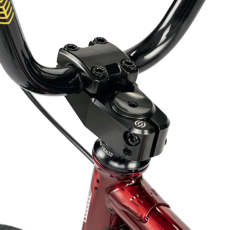 Close-up of a black BMX handlebar stem on the Wethepeople CRS 18 Inch Bike, an 18-inch BMX ideal for kids, shown here in red.