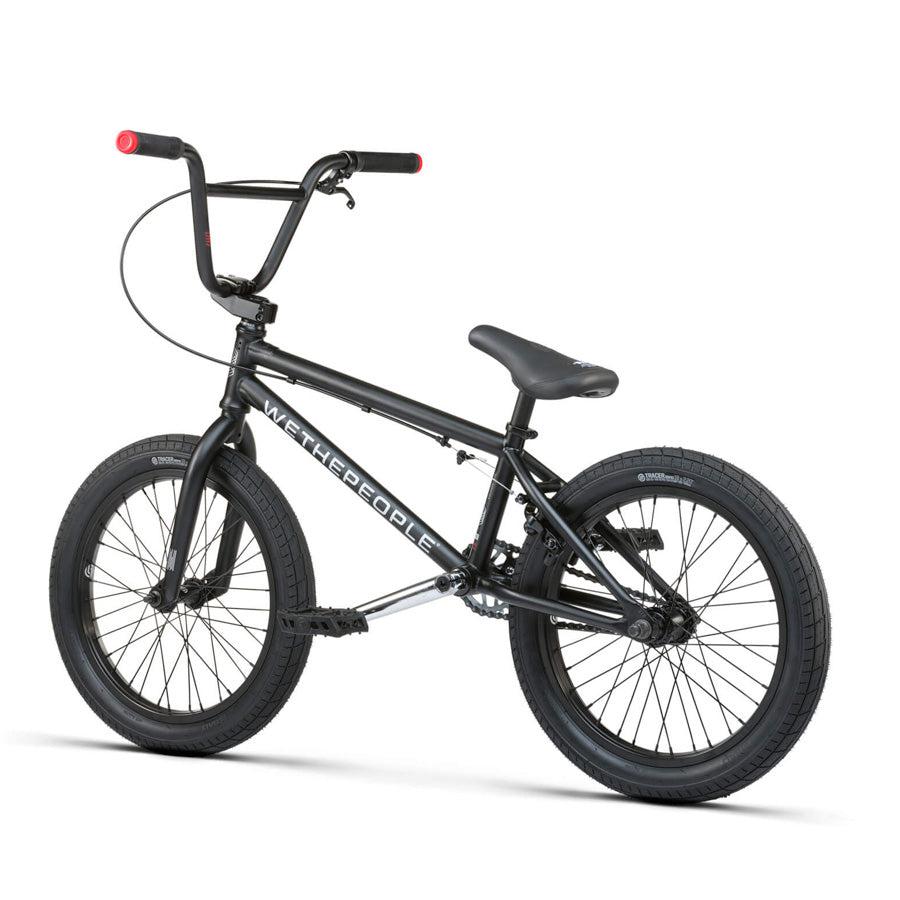 A Wethepeople CRS 18 Inch Bike for kids, featuring black color with red handlebar grips, thick tires, and bold "WETHEPEOPLE" branding on the frame—all shown on a white background.