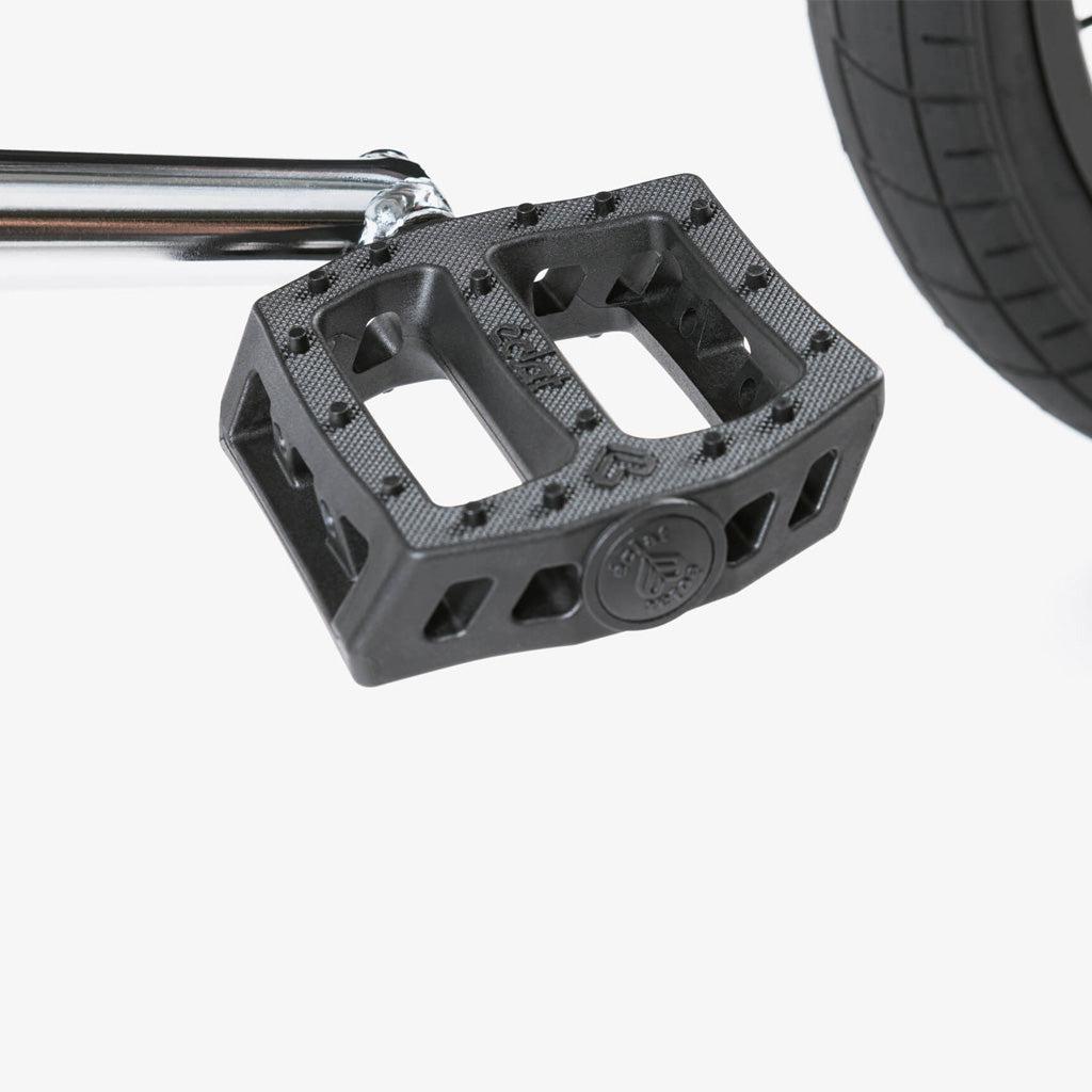 A pair of black Eclat Surge pedals on a Wethepeople CRS 20 Inch Bike.