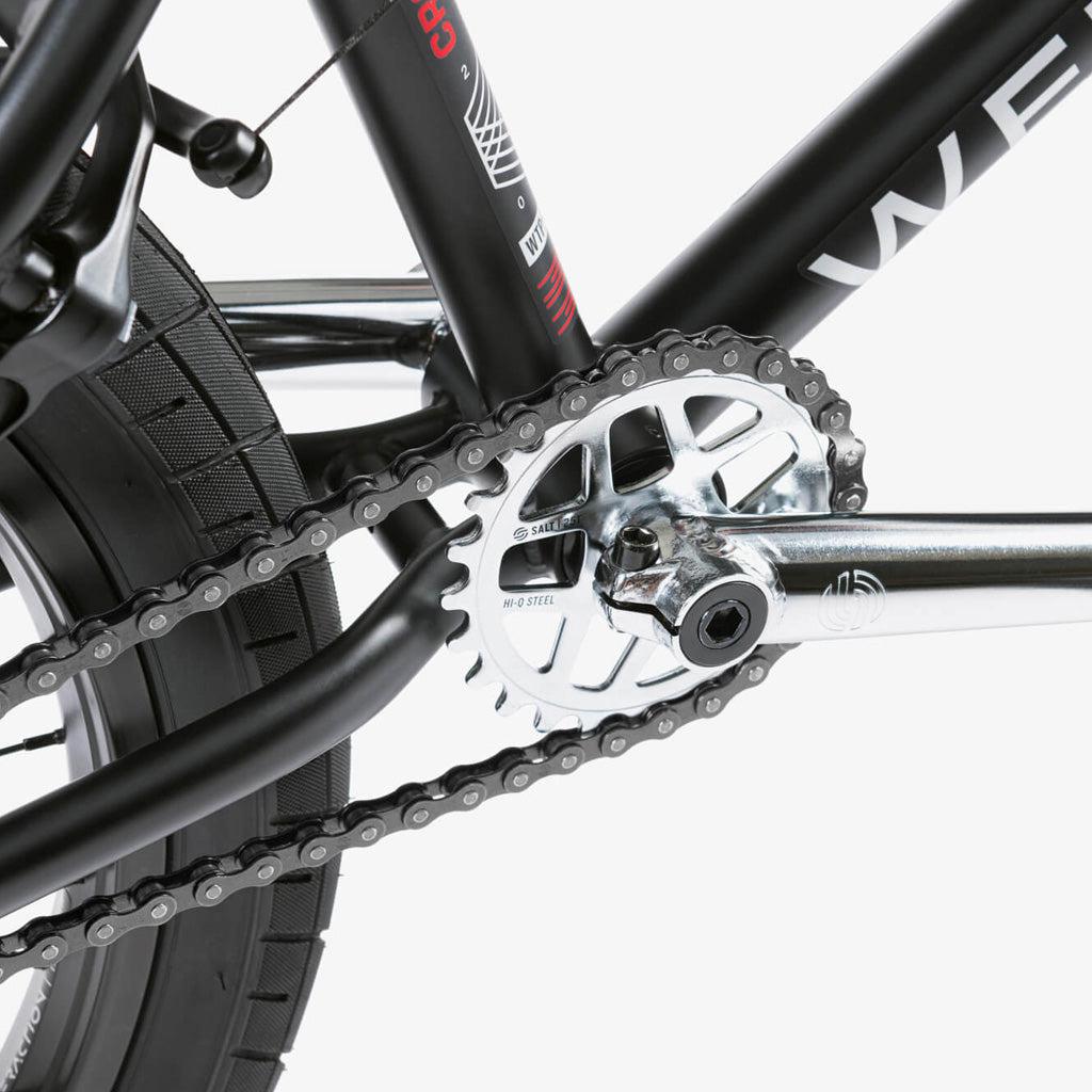 A close-up of the chain on a Wethepeople CRS 20 Inch Bike, featuring Salt Rookie Chromoly Three Piece Cranks and Eclat Surge Pedals.