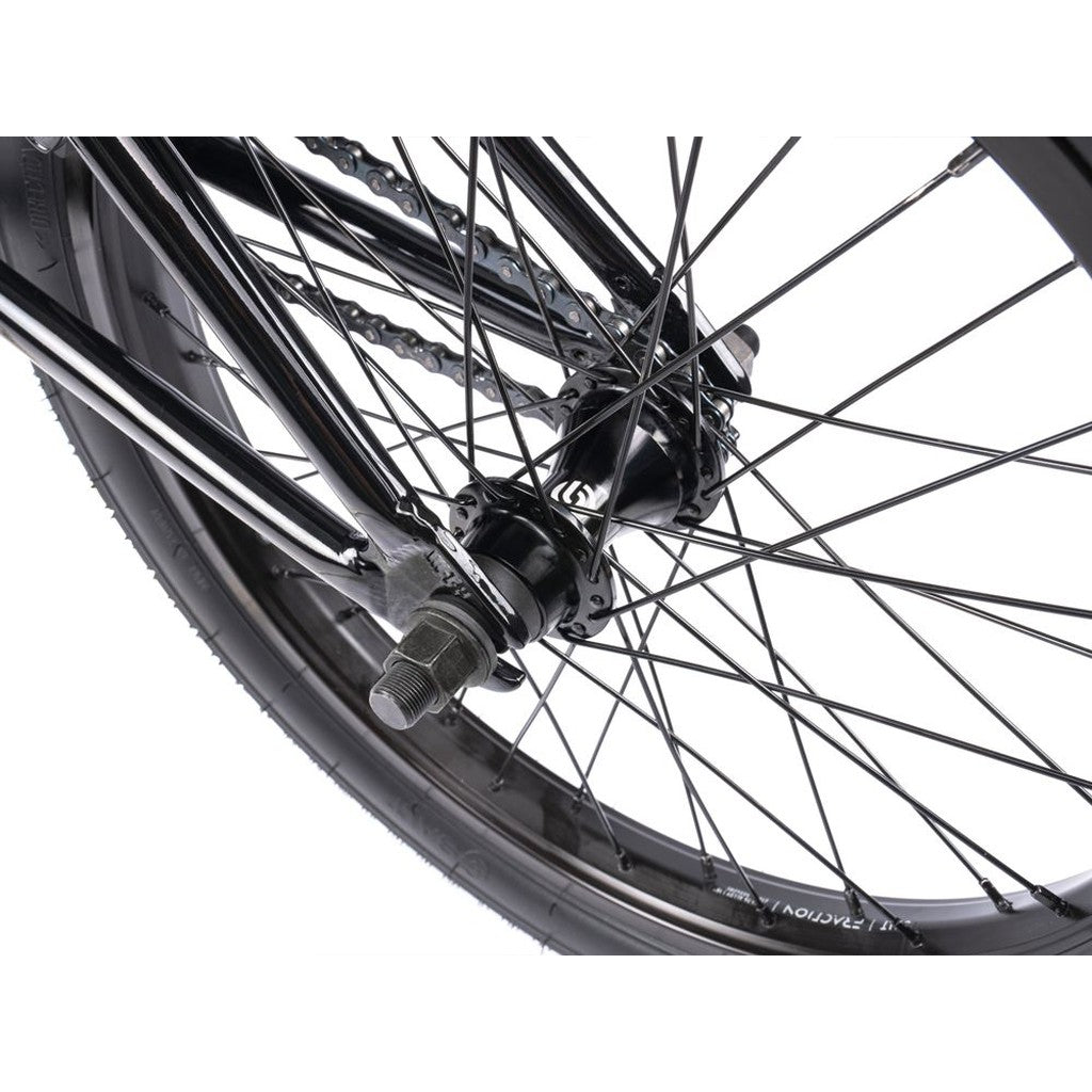 Close-up view of the Wethepeople CRS FS 18 Inch Bike's BMX freestyle rear wheel hub, displaying spokes, axle, and part of the tire against a white background.