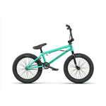The Wethepeople CRS FS 18 Inch Bike is a teal BMX freestyle bike with black tires, a padded seat, and straight handlebars, shown from the side on a white background.