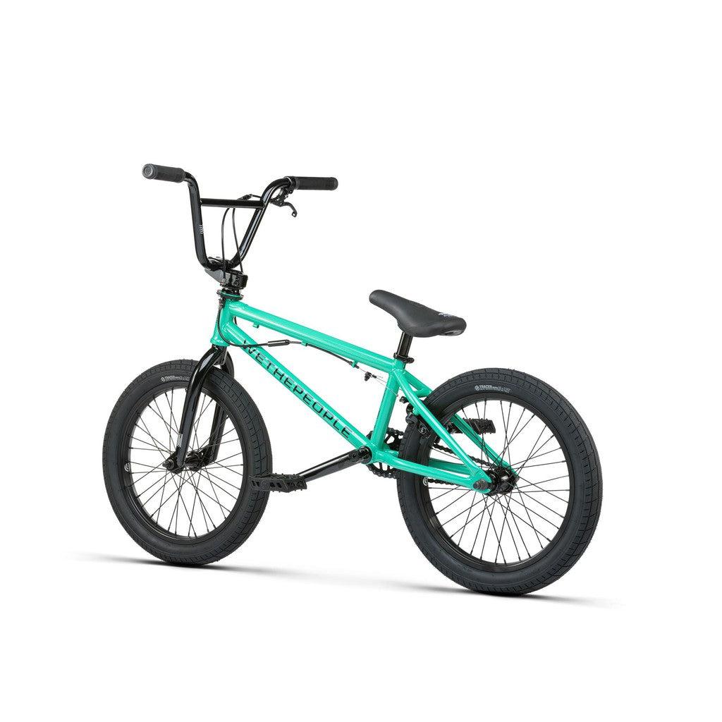 The Wethepeople CRS FS 18 Inch Bike is a teal BMX freestyle bike with black handlebars, seat, and tires, gyro equipped and featuring 18-inch wheels, shown on a white background.