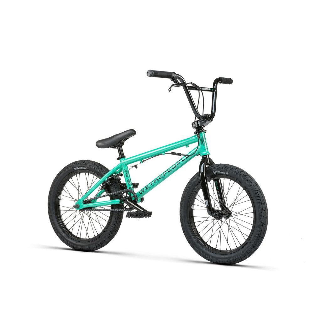 The Wethepeople CRS FS 18 Inch Bike, shown in teal with black handlebars, seat, and tires, is angled to the right against a white background. This gyro-equipped BMX model is ideal for tricks and stunts.