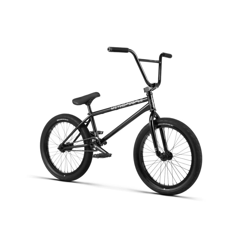 A Wethepeople Envy 20 Inch Bike in black with thick tires, Eclat components, a padded seat, straight handlebars, and pedals is photographed on a white background.