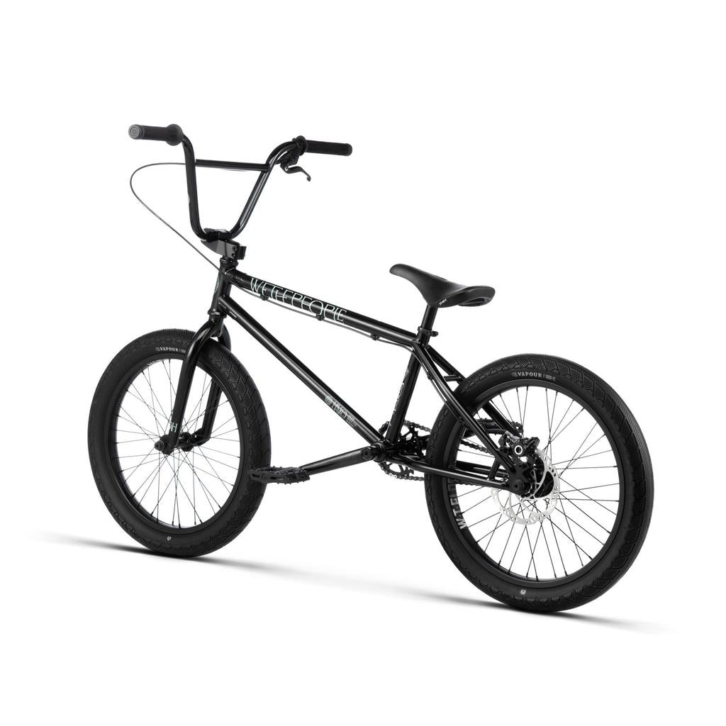 The Wethepeople Havoc 20 Inch Bike, featuring a black compact Chromo frame, thick tires, and raised handlebars, is displayed against a white background.