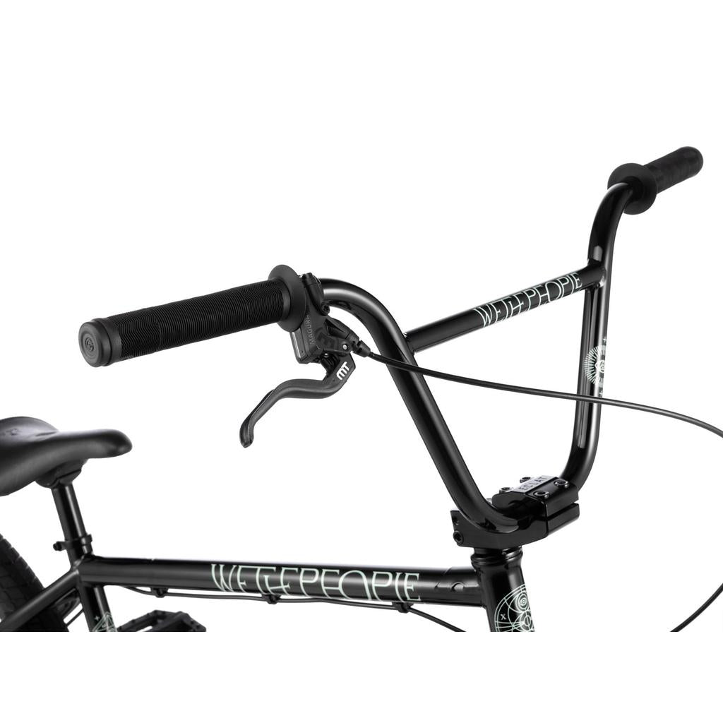 Close-up of a black BMX handlebar with hand grips and brake lever, featuring “Wethepeople Havoc 22 Inch Bike” branding on the frame and handlebars.
